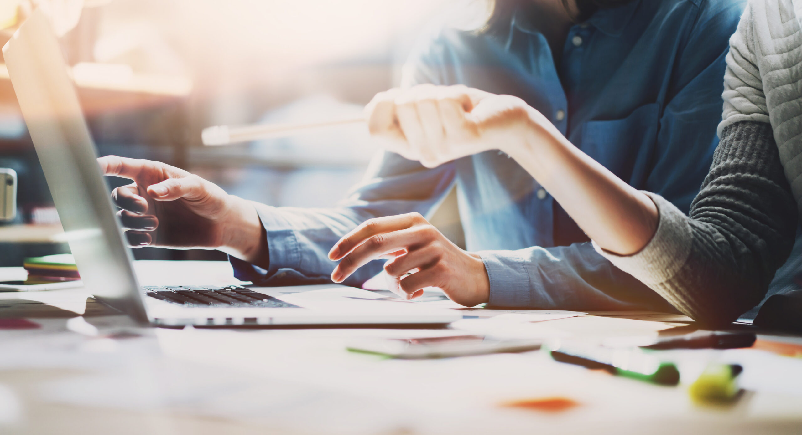 Business meeting time. Photo young account managers crew working with new startup project. Notebook on wood table. Idea presentation, analyze plans. Wide,film effect AmplusYextPartnership scaled 1