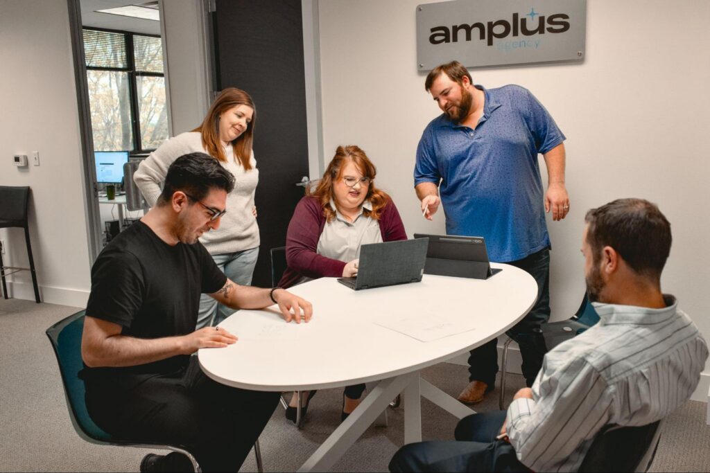 The Amplus Agency team planning a full-service digital marketing campaign together in their office